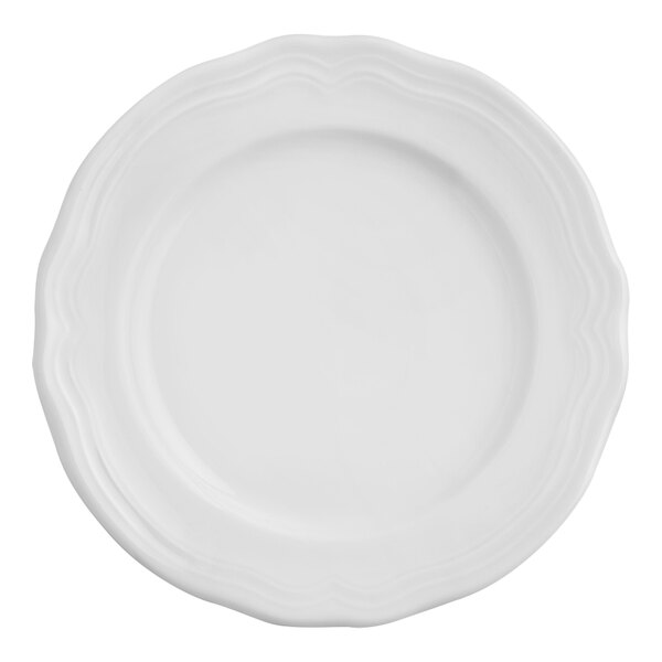 An Arcoroc Athena white porcelain plate with a scalloped edge.