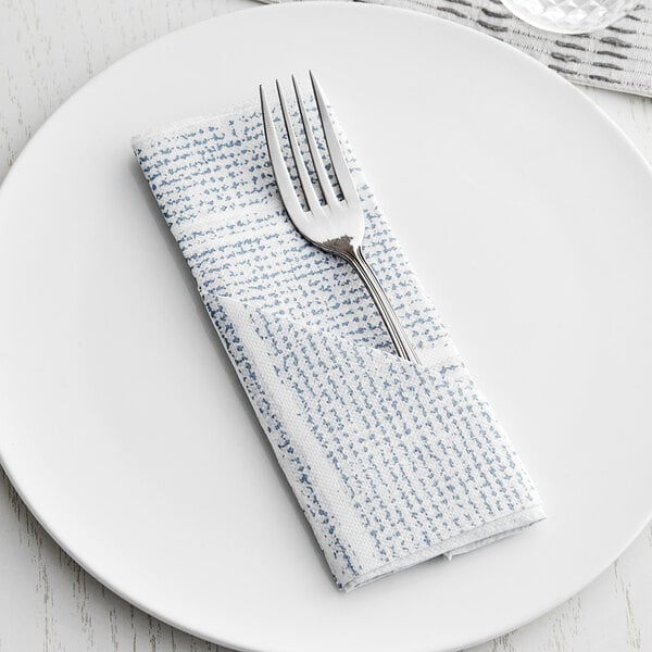 A blue and white Hoffmaster FashnPoint dinner napkin with a fork on a plate.