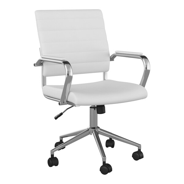 A Martha Stewart white faux leather office chair with chrome wheels.