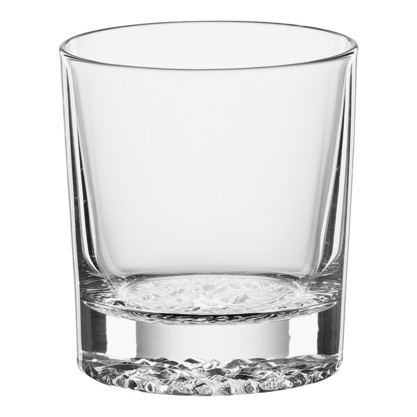 A clear Spiegelau Lounge 2.0 Rocks glass with a small amount of water in it.