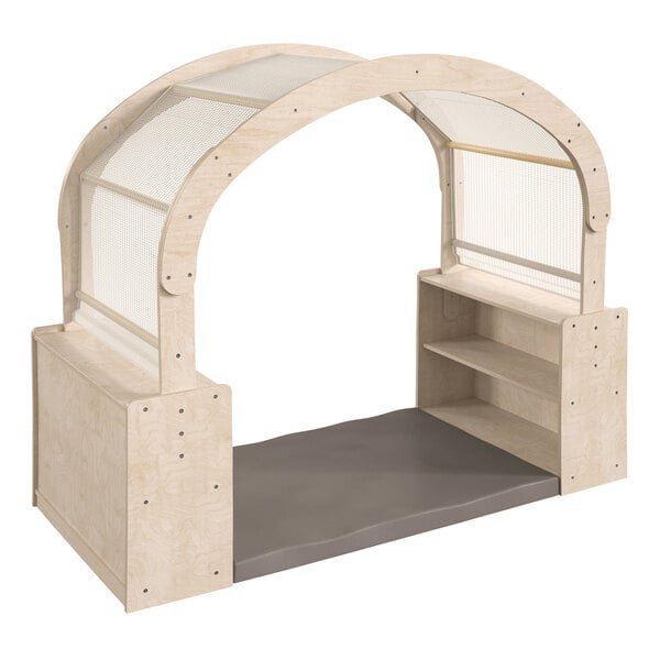 A wooden reading nook with a white cover and wooden arches.