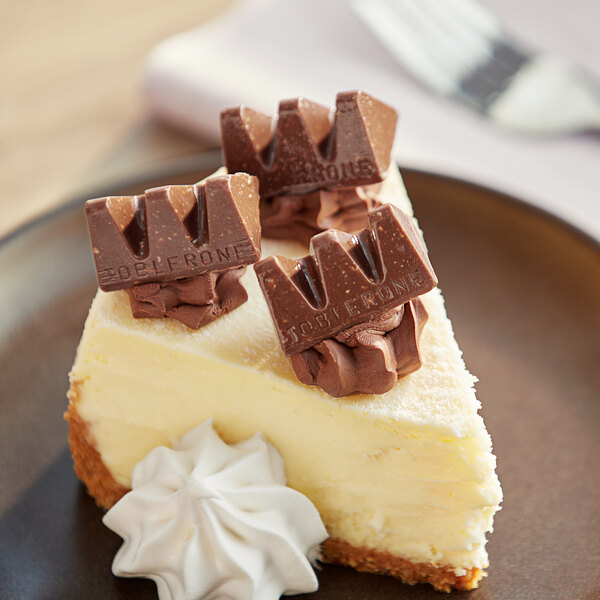 A piece of cheesecake with Toblerone chocolate on top.