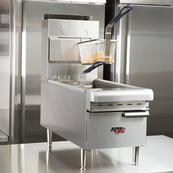 An APW Wyott natural gas countertop fryer with a basket on top.