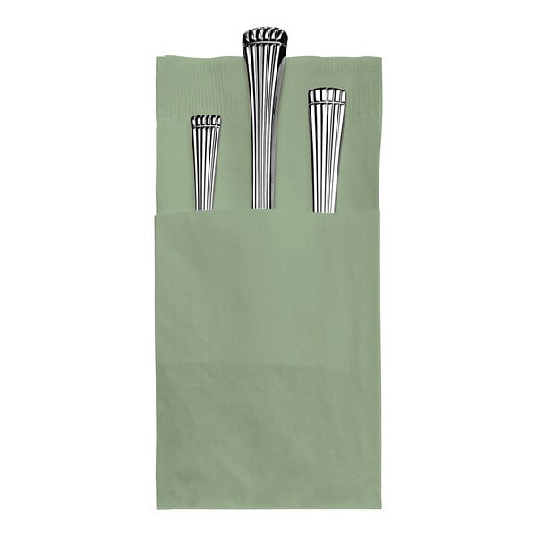 A silverware set wrapped in a soft sage green Hoffmaster Quickset dinner napkin.