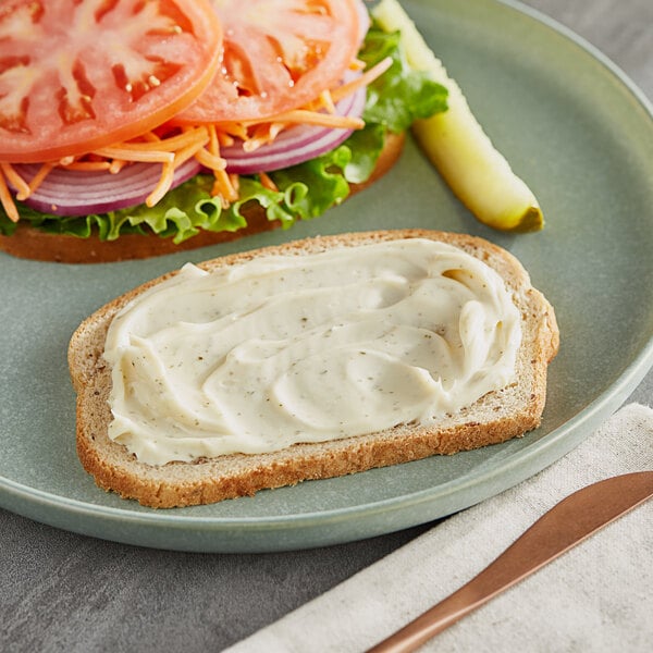 A piece of bread with Only Plant Based Vegan Garlic Mayonnaise spread on it.
