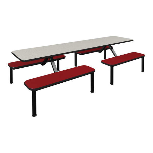 A white table with red benches in a school cafeteria.