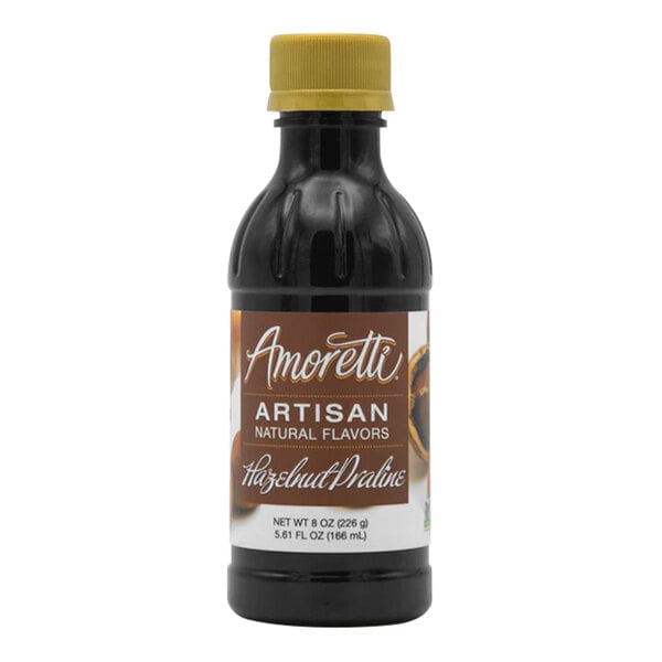 A bottle of Amoretti Hazelnut Praline Artisan Natural Flavor Paste with a brown label and brown liquid.