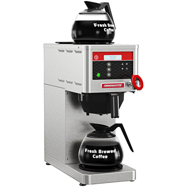 A Grindmaster automatic coffee brewer with a kettle on top.