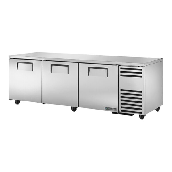 A True stainless steel undercounter refrigerator with three doors.