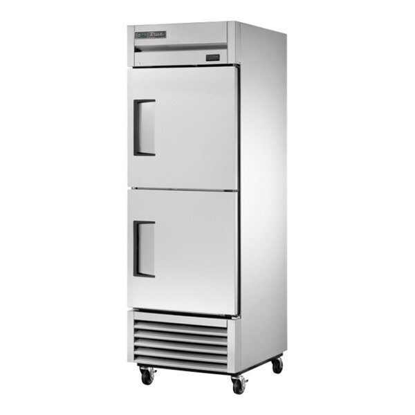 A white True reach-in freezer with black handles.