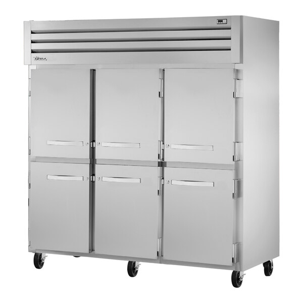A True reach-in refrigerator with white solid half doors.
