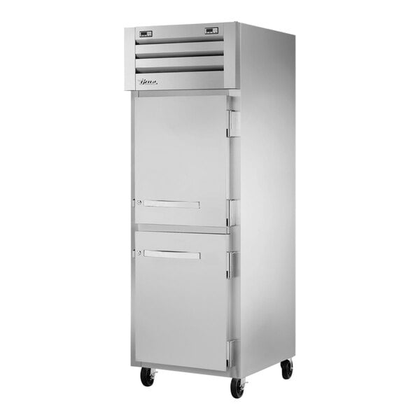 A silver True Spec Series combination refrigerator/freezer with two half doors.