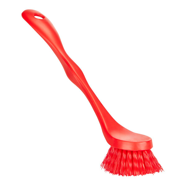 A close up of a Remco red dish brush with a handle.