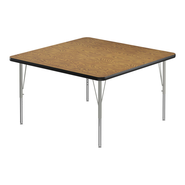 A square table with a medium oak top and black edges on metal legs.
