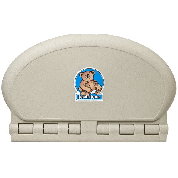 A Koala Kare sandstone plastic baby changing station with a logo on it.