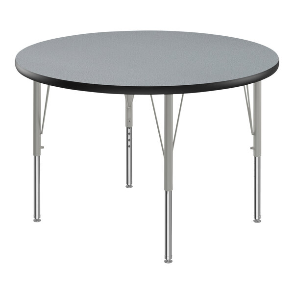 A round Correll activity table with silver metal legs and a gray granite top.