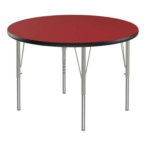 A red and black round Correll activity table with metal legs.