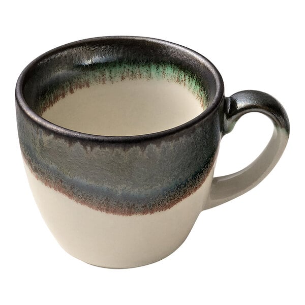 A white porcelain espresso cup with a green and blue striped handle.
