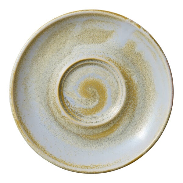 A close-up of a white Heart & Soul Breeze porcelain saucer with a yellow spiral pattern.
