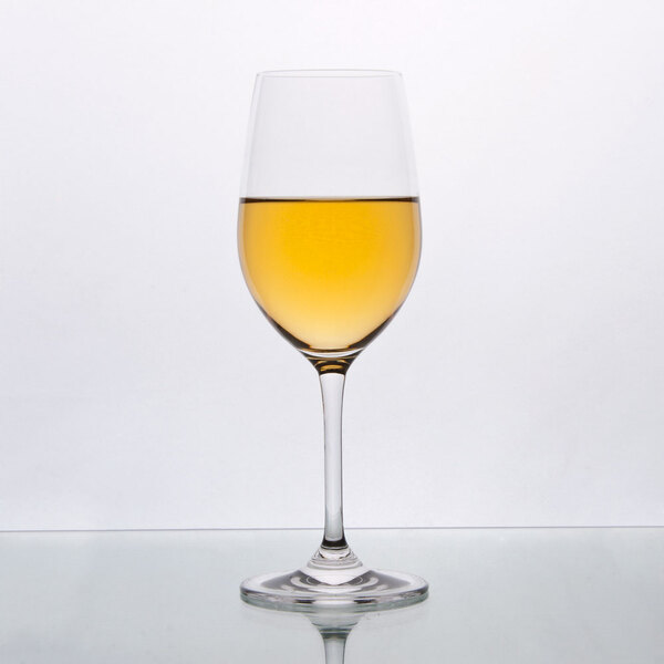 A Stolzle Chardonnay wine glass filled with yellow liquid.