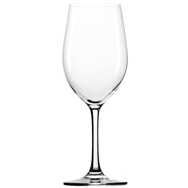A close-up of a clear Stolzle Chardonnay wine glass with a stem.