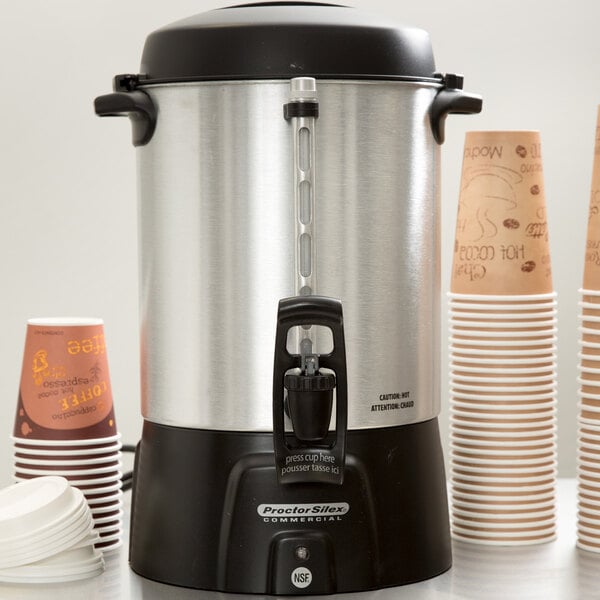 A Proctor Silex coffee urn with cups inside.
