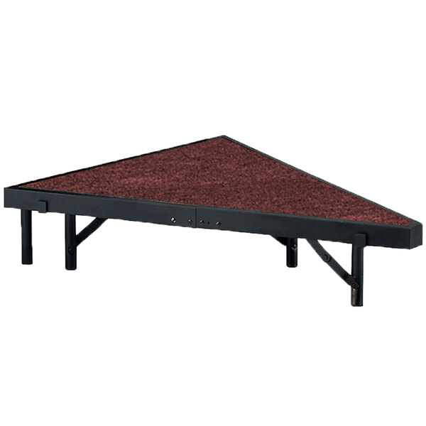 A red and black triangular platform with a red carpet surface.