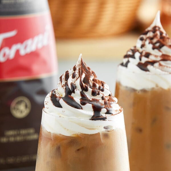 Two iced coffee drinks topped with whipped cream and Torani Sugar-Free Dark Chocolate Flavoring Sauce.