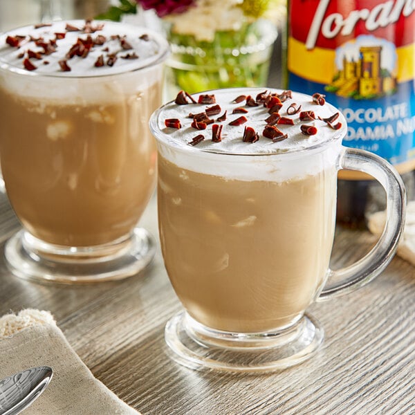 A glass mug of coffee with Torani Chocolate Macadamia Nut flavoring on top.
