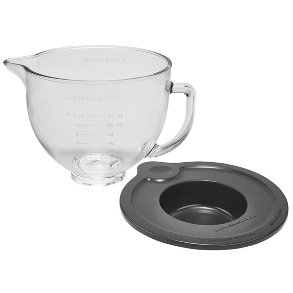 A clear glass bowl with a lid and handle for a KitchenAid mixer.