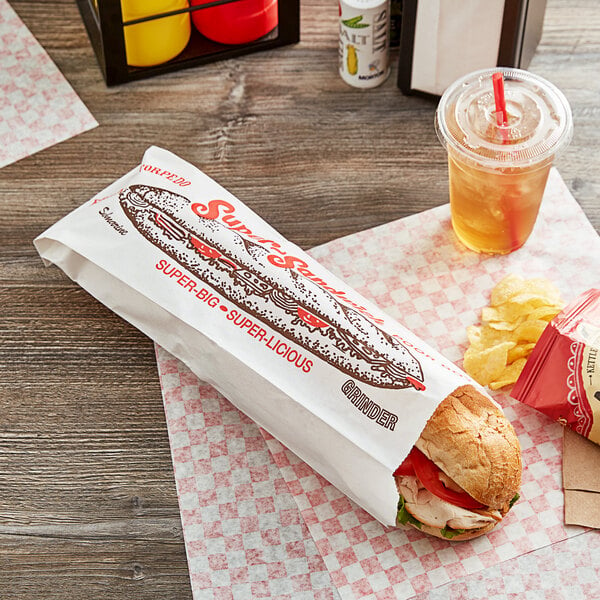 A submarine sandwich in a Choice paper bag on a table.