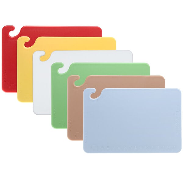 A group of colorful plastic San Jamar cutting boards.
