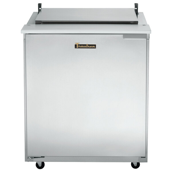 A stainless steel Traulsen refrigerated sandwich prep table with a black rectangular label on top.