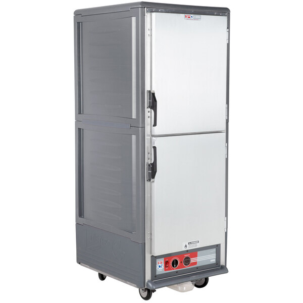 A gray Metro C5 heated holding cabinet with Dutch doors on wheels.