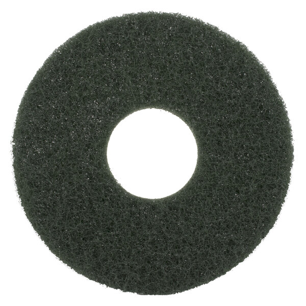 A black circular Scrubble floor pad with a white circle in the middle.
