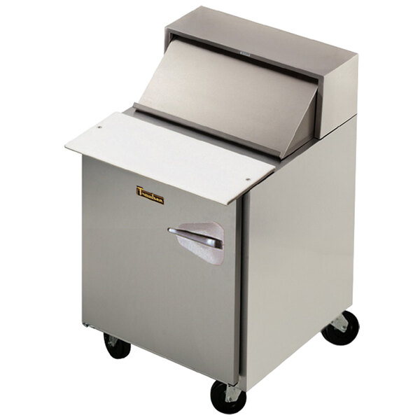 A large silver Traulsen refrigerated sandwich prep table on wheels.