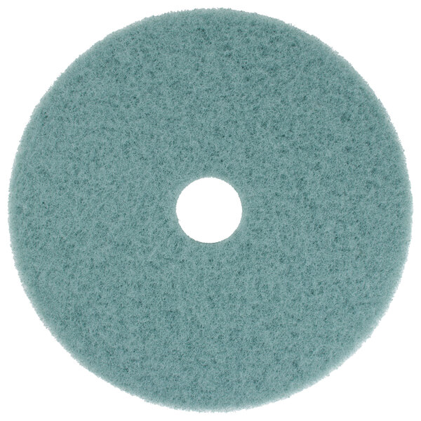 A blue circular Scrubble Aqua Burnishing floor pad with a hole in the middle.