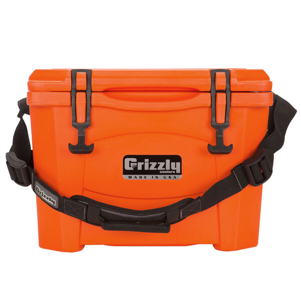 An orange Grizzly cooler with black straps.