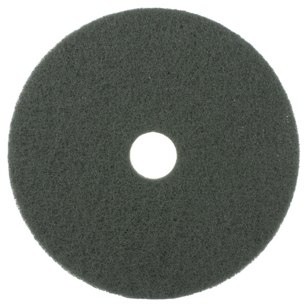 A green Scrubble 20" circular floor pad with a hole in the middle.
