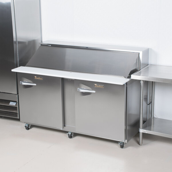 A large stainless steel Traulsen refrigerator with two right hinged doors above a cabinet.