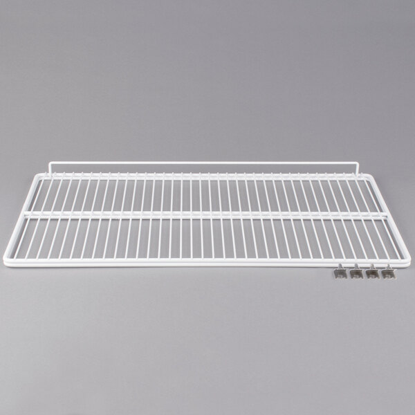 A white wire shelf with metal clips.