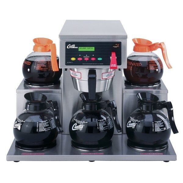 A Curtis commercial coffee brewer with five coffee pots on the lower warmers.