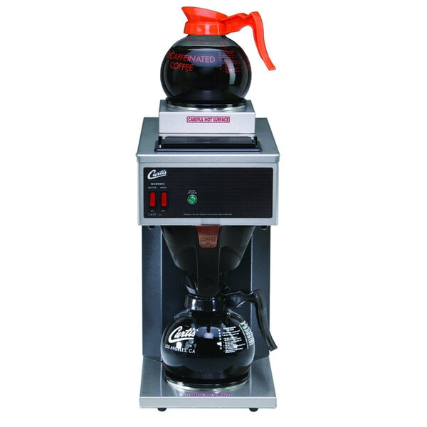 A Curtis commercial pourover coffee maker with a black base and red plastic lids.