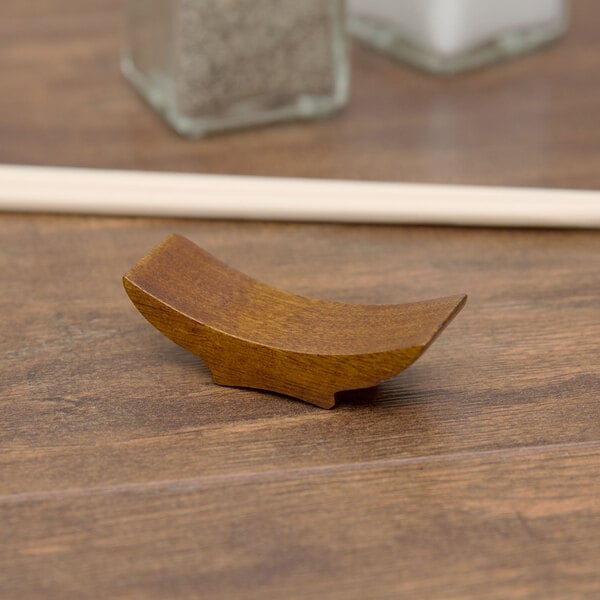 A Town wooden chopstick rest on a table.