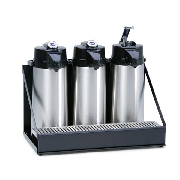 A black Curtis three airpot rack holding stainless steel coffee containers.