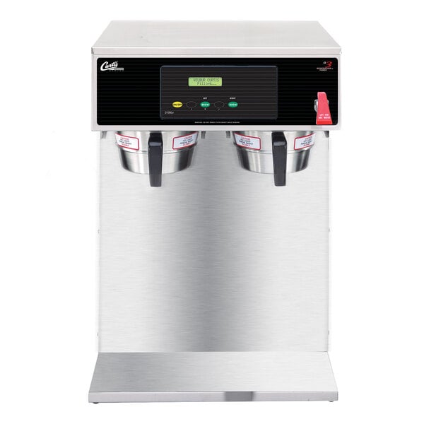 A silver and black Curtis airpot coffee machine with two cups on top.