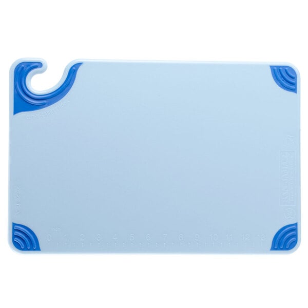 A white and blue cutting board with a blue handle.