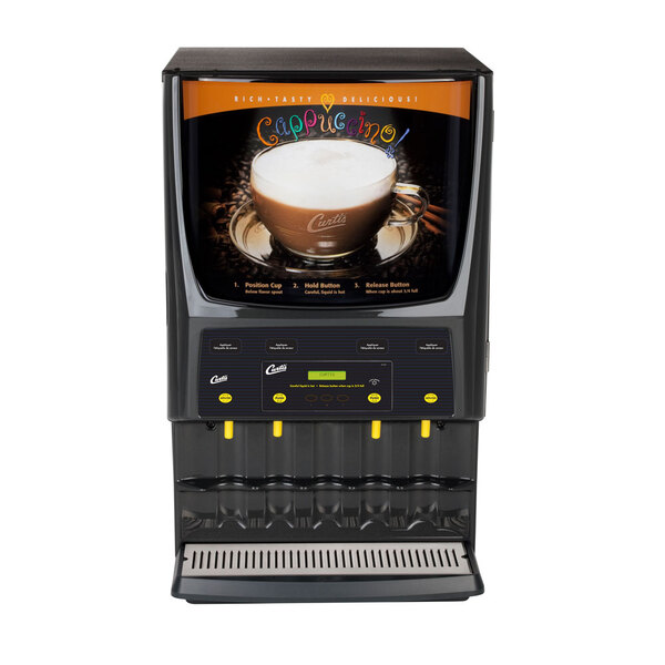 A Curtis Primo Cappuccino Dispenser with a cup of cappuccino on it.
