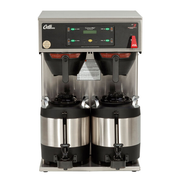 A Curtis ThermoPro Twin coffee brewer with two coffee containers on top.