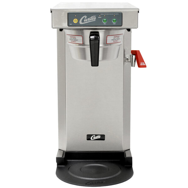 A silver and black Curtis airpot coffee brewer on a counter.